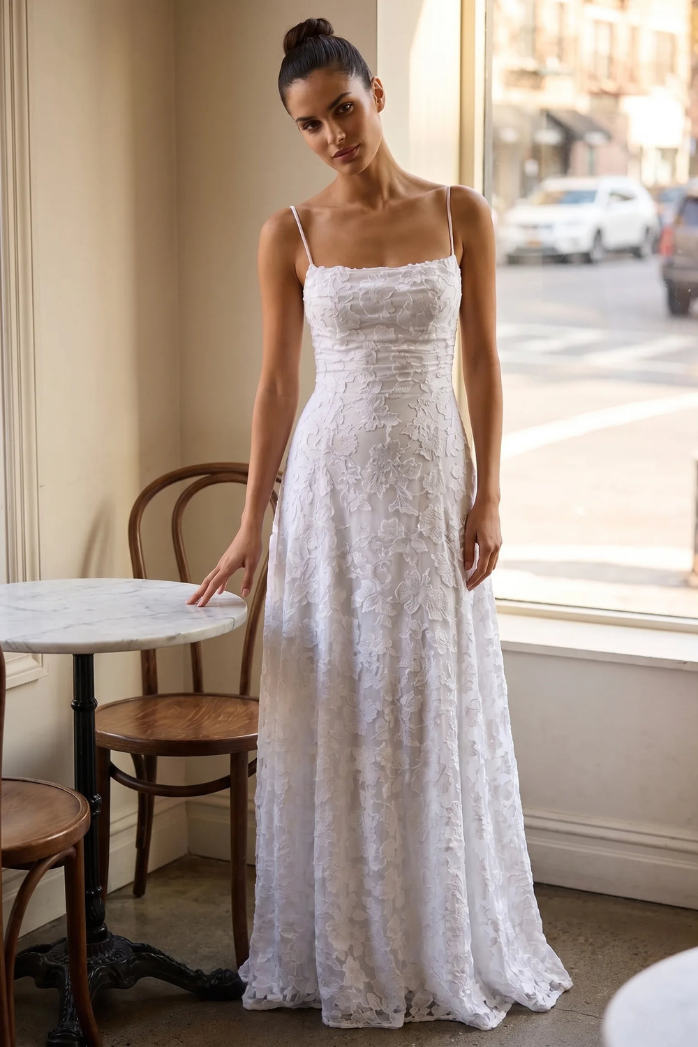 Model wearing white jacquard ruched maxi dress in lifestyle setting