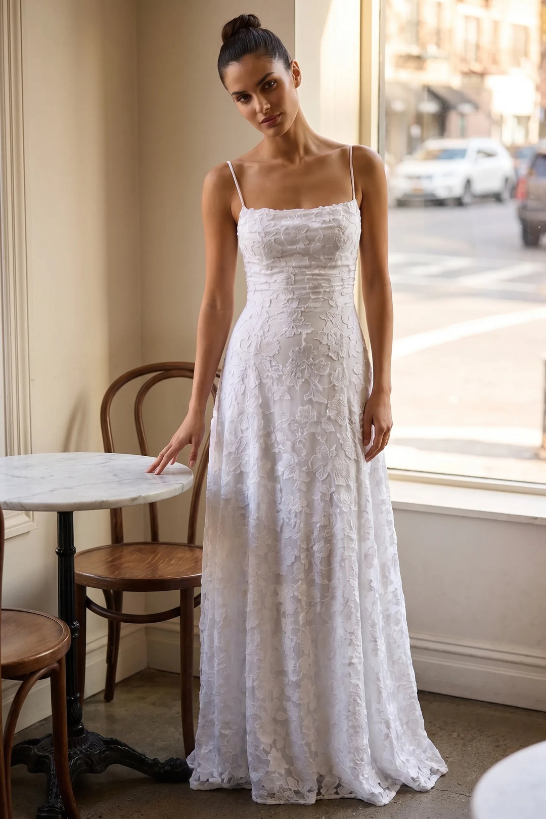 Model wearing white jacquard ruched maxi dress in lifestyle setting