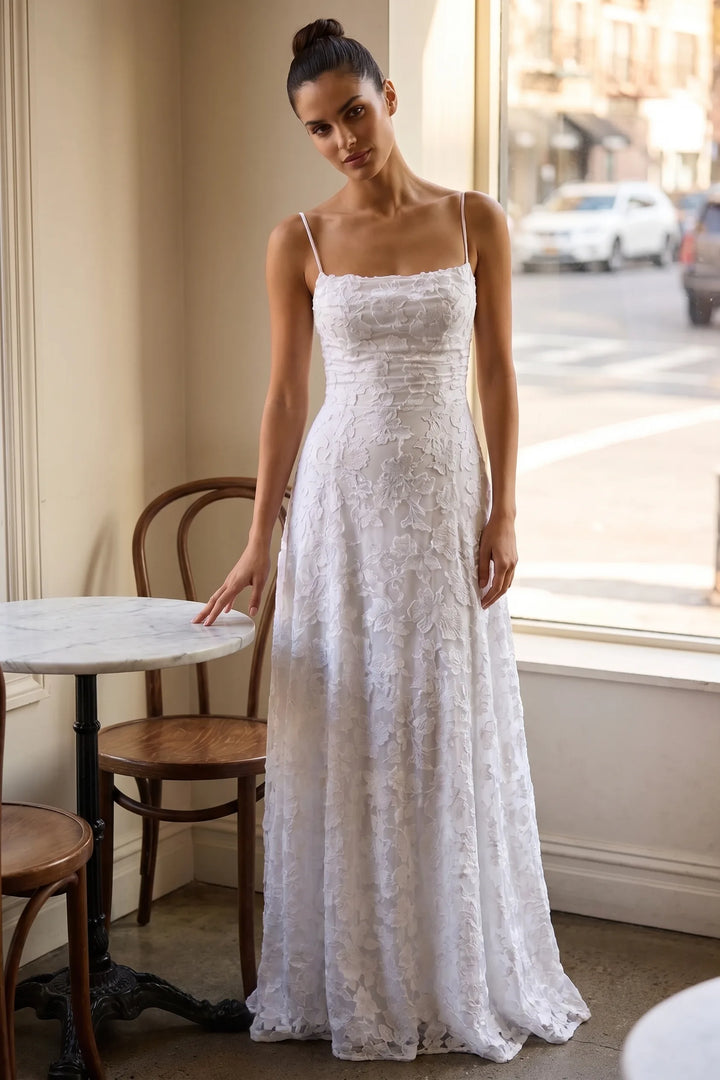 Model wearing white jacquard ruched maxi dress in lifestyle setting