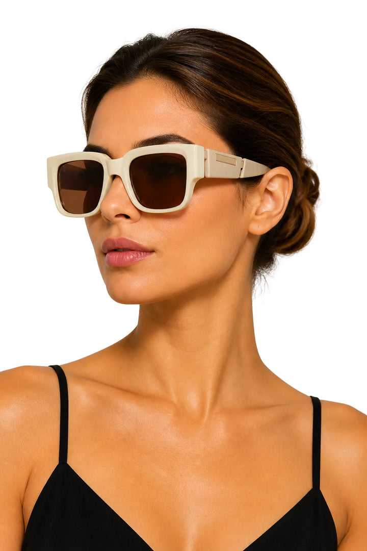 Model wearing oversized two-tone square sunglasses in off-white, facing forward