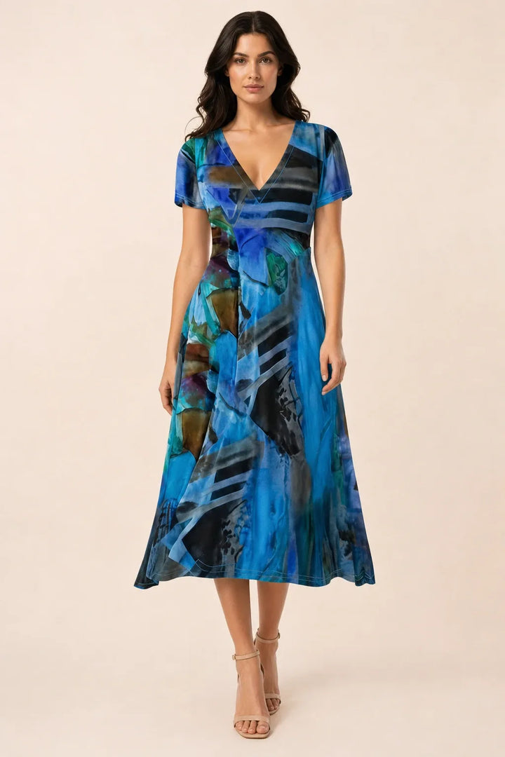 Blue abstract print midi dress on model in contrapposto stance