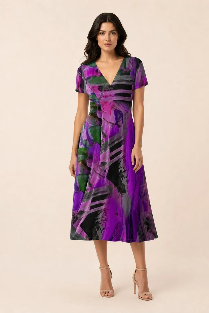 Purple abstract print midi dress on model in contrapposto stance