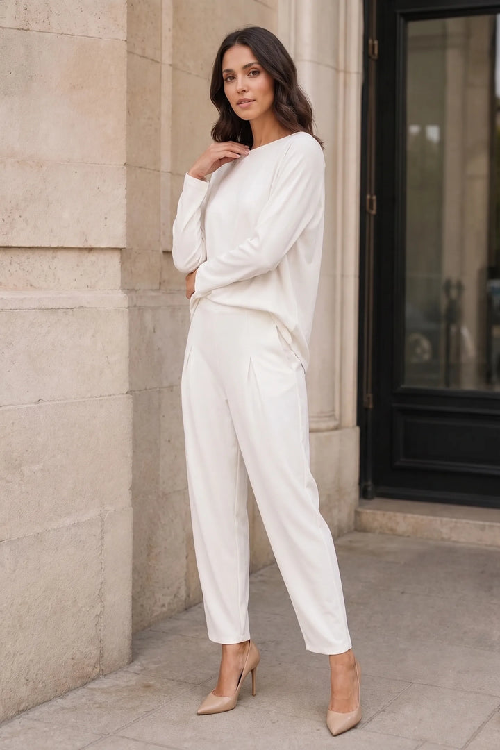 Off-white bateau neck knit trouser set on model in three-quarter turn