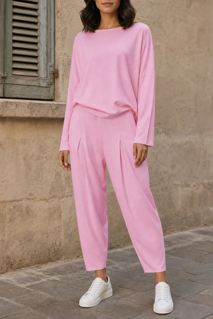 Pink bateau neck knit trouser set on model in contrapposto stance
