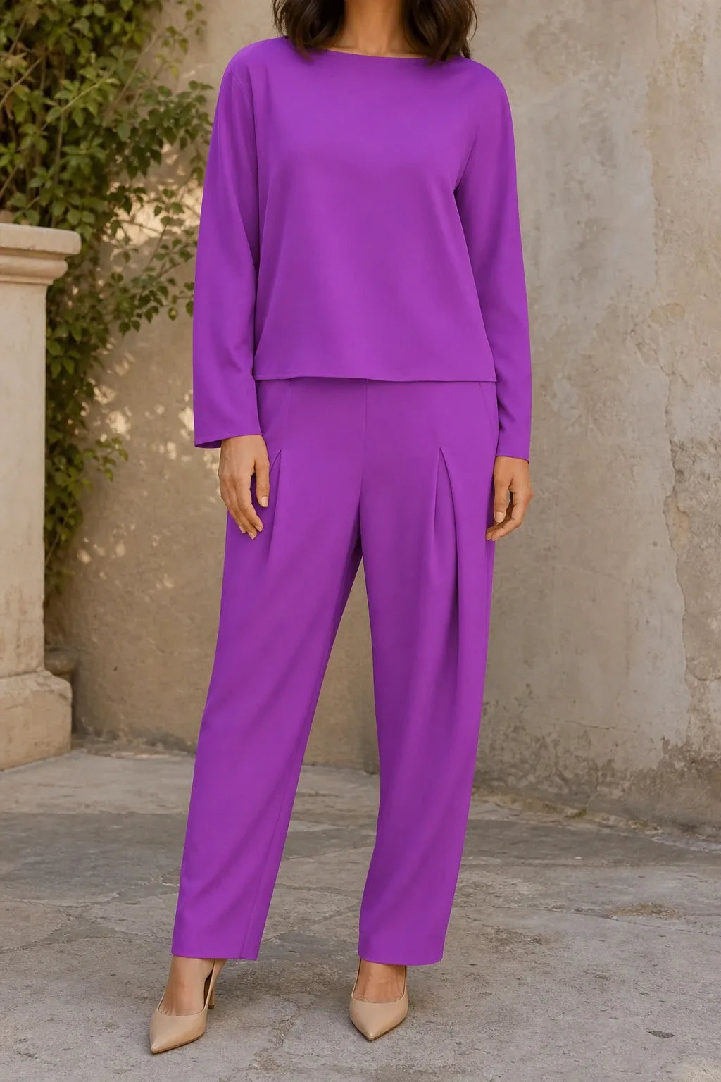 Purple bateau neck knit trouser set on model in contrapposto stance