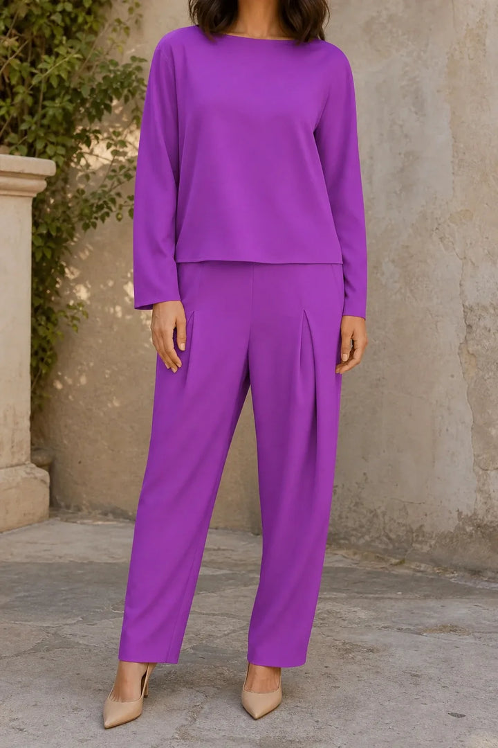 Purple bateau neck knit trouser set on model in contrapposto stance