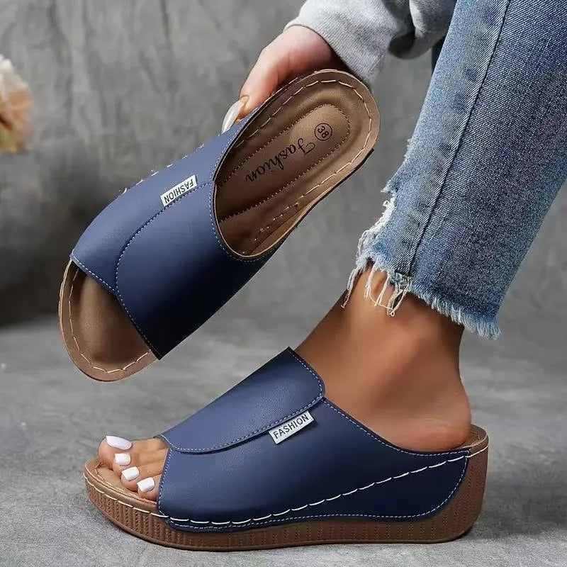 Blue wedge platform mule, close-up detail view of texture and construction