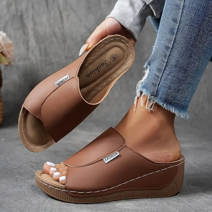 Brown wedge platform mule, side profile highlighting wedge heel height and silhouette