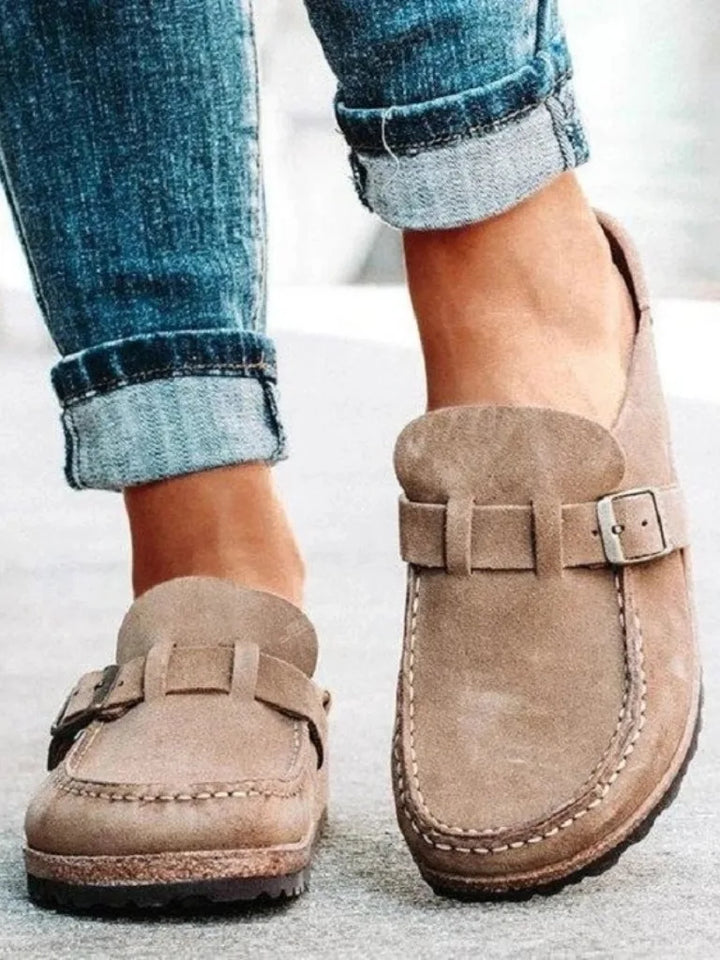 Beige buckle strap clog mule, three-quarter angle view
