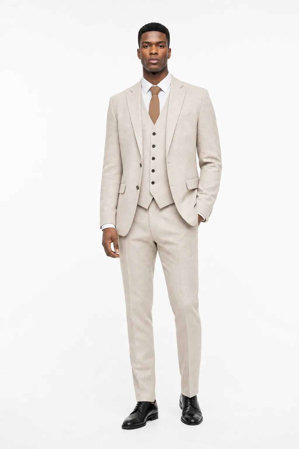 Beige linen three-piece suit on a model in a contrapposto stance