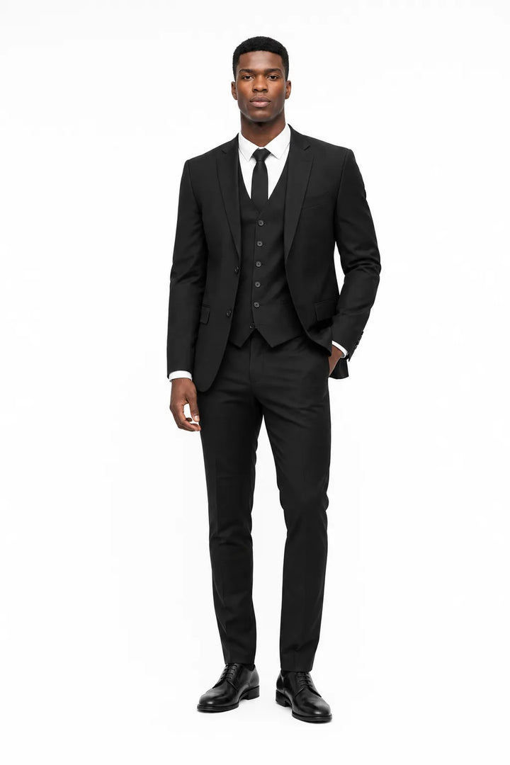 Black linen three-piece suit on a model in a contrapposto stance