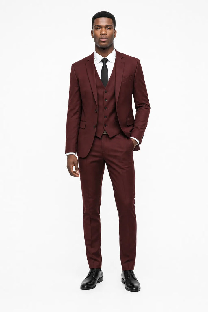 Burgundy linen three-piece suit on a model in a contrapposto stance