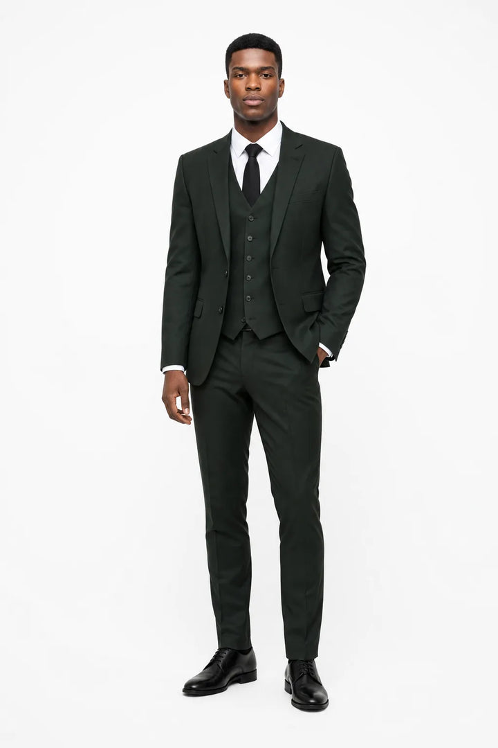 Green linen three-piece suit on a model in a contrapposto stance