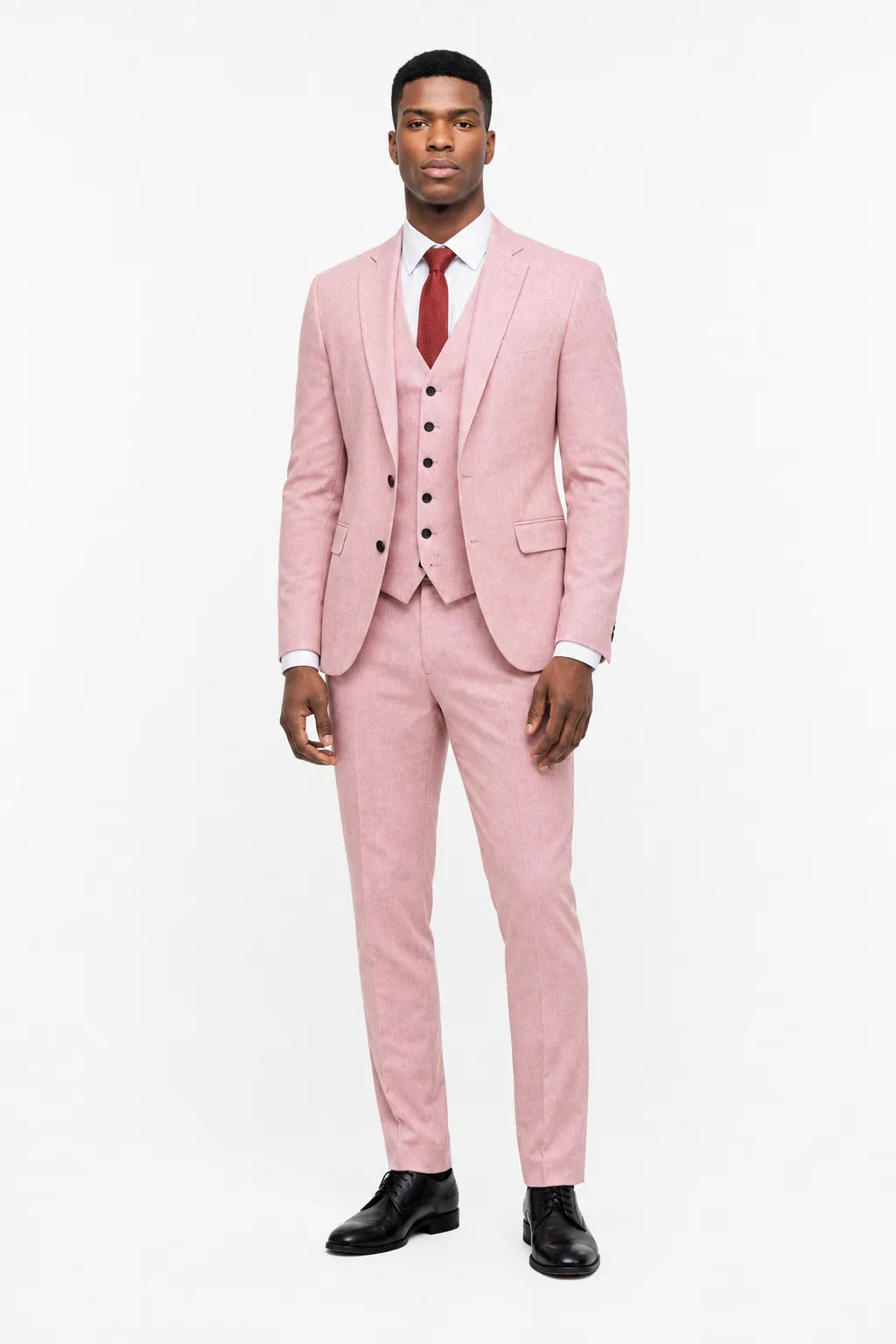 Pink linen three-piece suit on a model in a contrapposto stance
