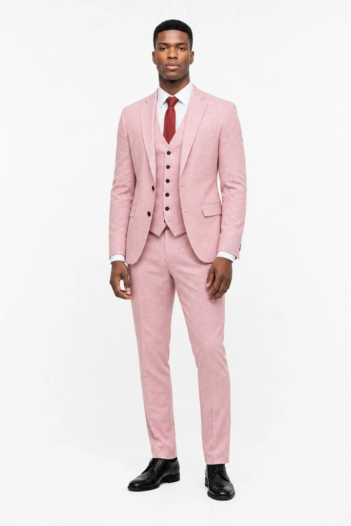 Pink linen three-piece suit on a model in a contrapposto stance