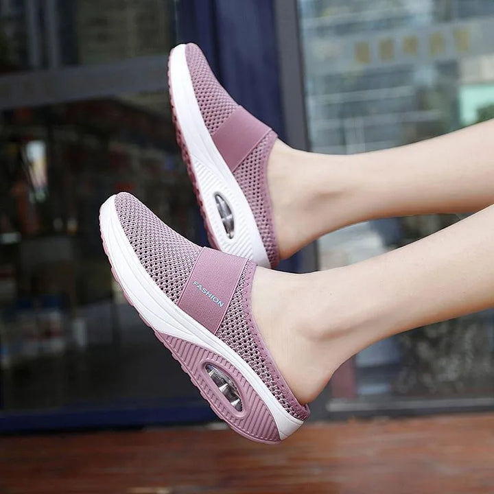 Red cushioned slip-on mule sneaker, side profile view