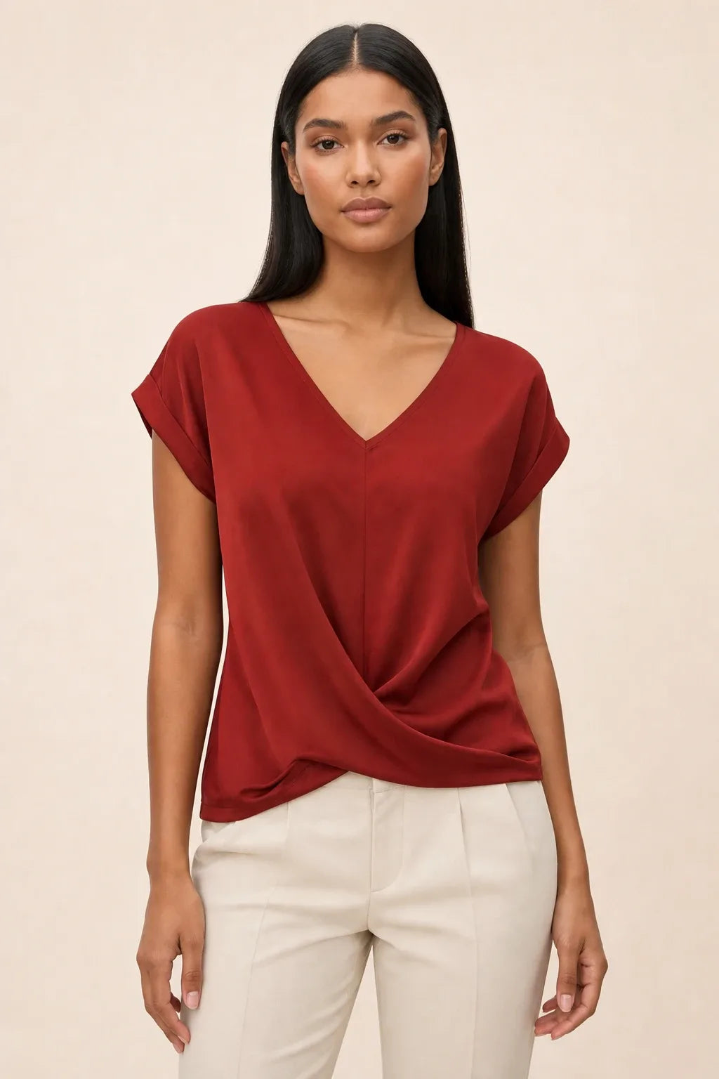 Red twist-front cap sleeve top on a model in a contrapposto stance