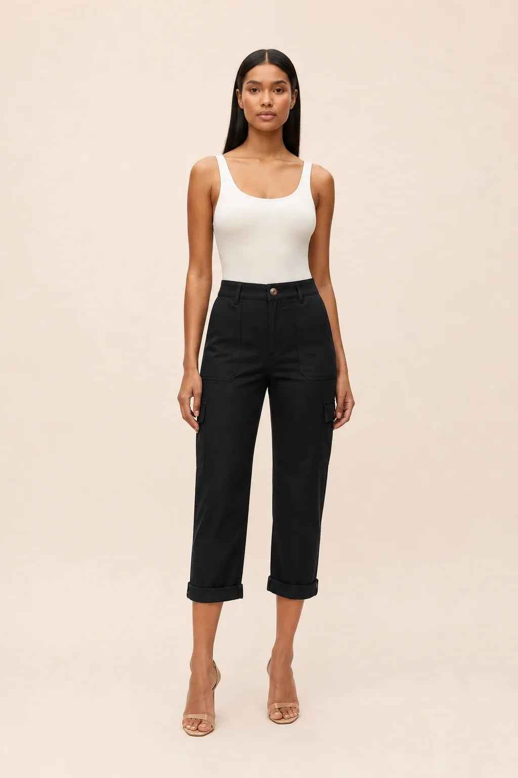 Black cargo capri pants on a model in a contrapposto stance, featuring side cargo pockets