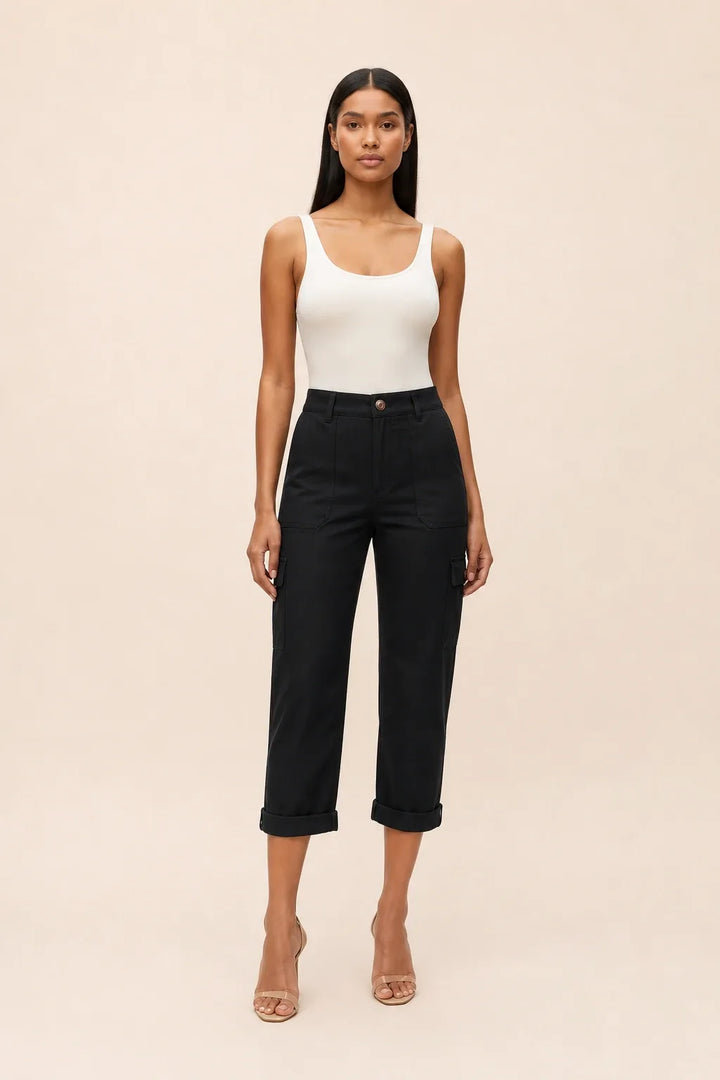 Black cargo capri pants on a model in a contrapposto stance, featuring side cargo pockets