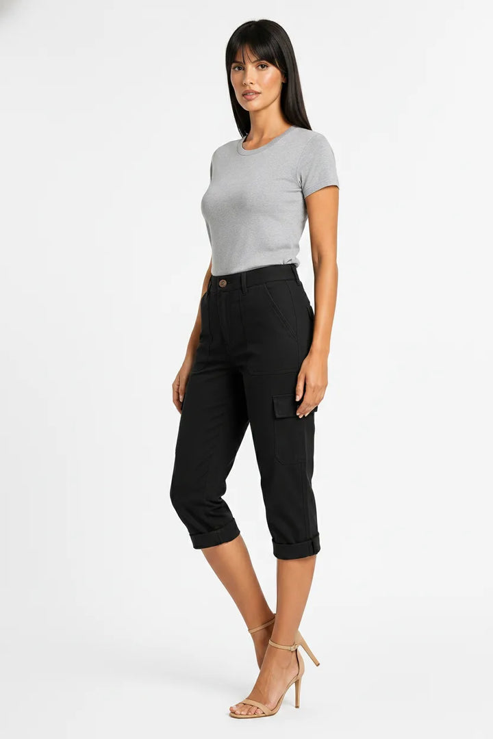 Black cargo capri pants with side pockets on a model in a three-quarter turn