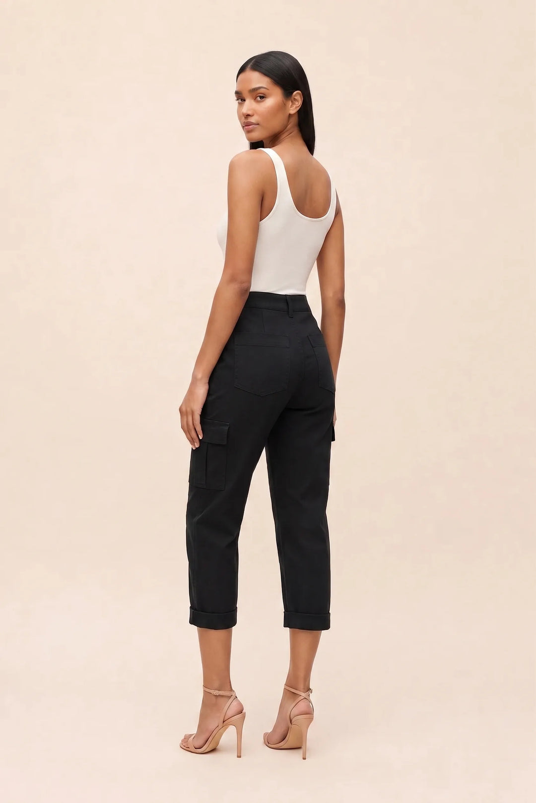 Black cargo capri pants on a model in a three-quarter turn, showing back and side details