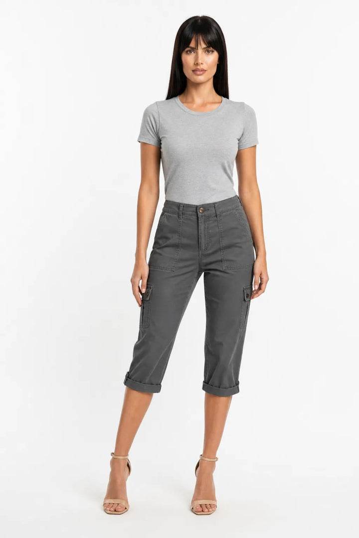 Dark gray cargo capri pants with side pockets on a model in a contrapposto stance