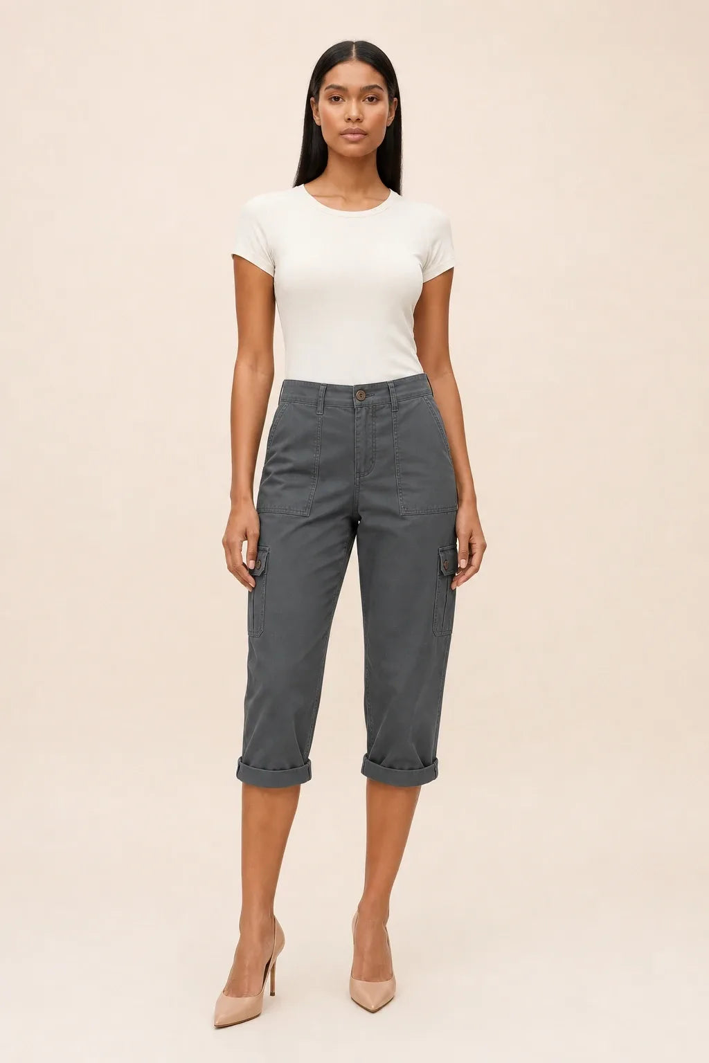 Dark gray cargo capri pants on a model in a contrapposto stance, with side cargo pockets