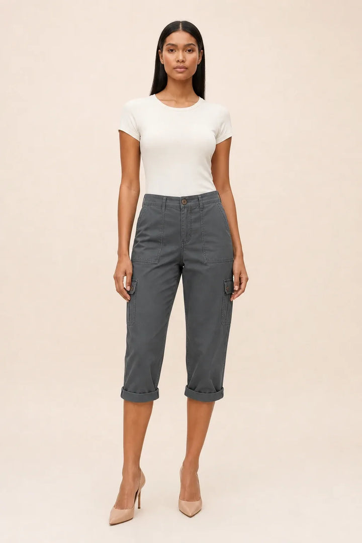 Dark gray cargo capri pants on a model in a contrapposto stance, with side cargo pockets