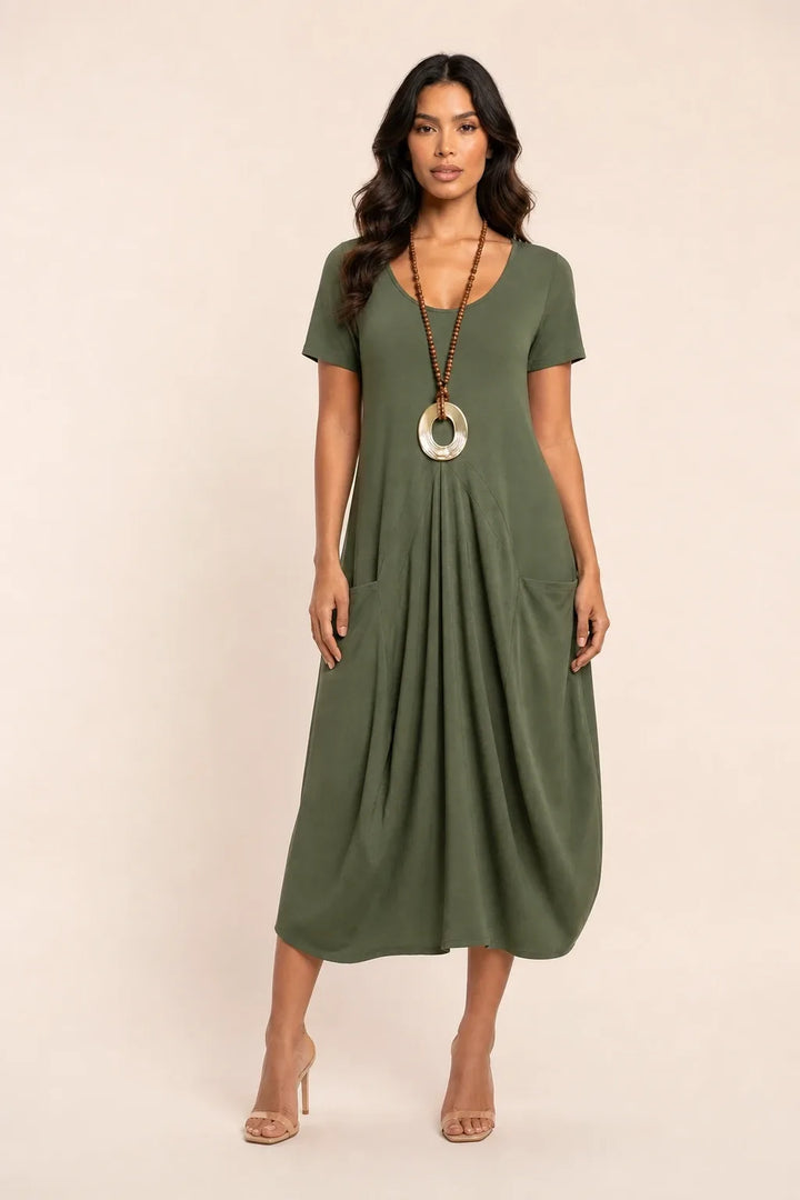 Green flowy midi dress with pockets on model in contrapposto stance