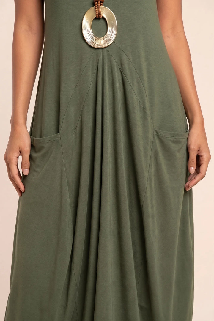 Close-up detail of green flowy midi dress with side pocket