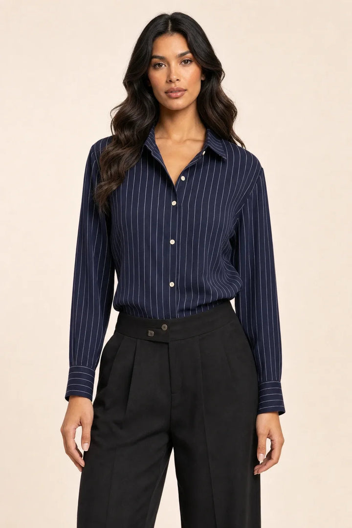 Blue pinstripe button-front blouse on model in contrapposto stance