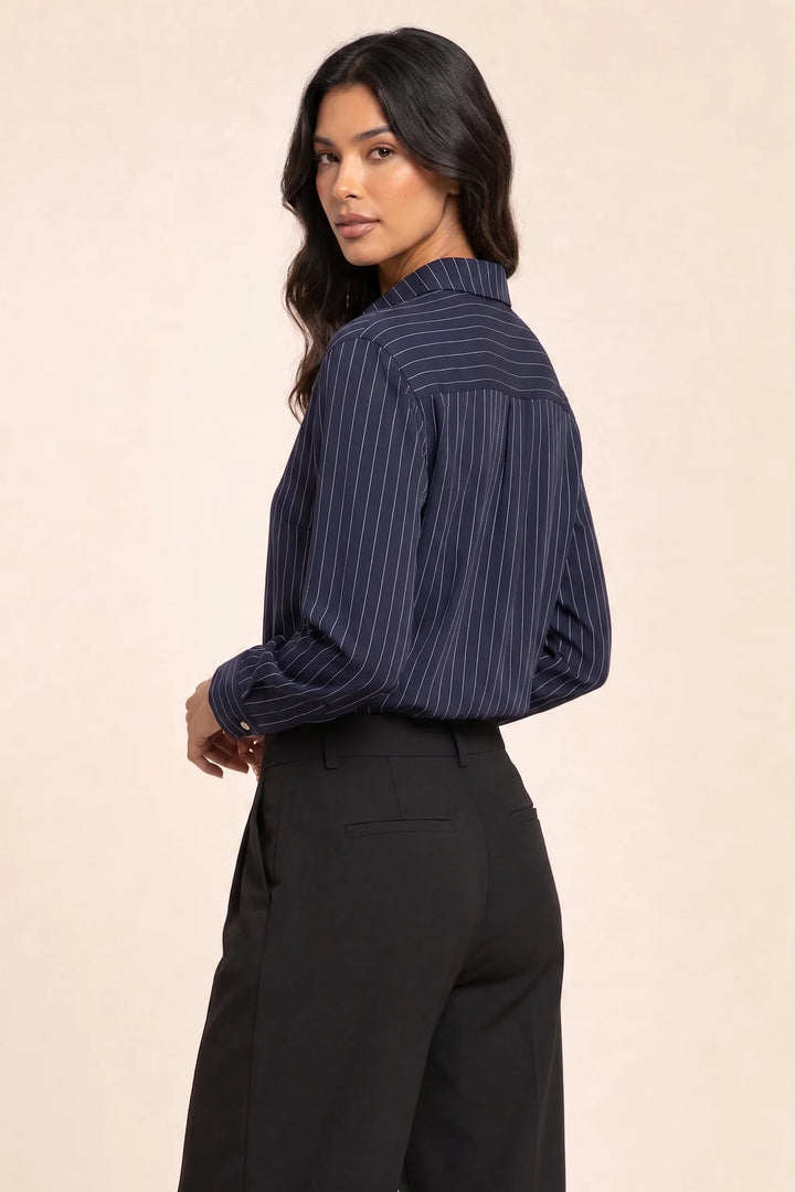 Blue pinstripe button-front blouse on model in three-quarter turn
