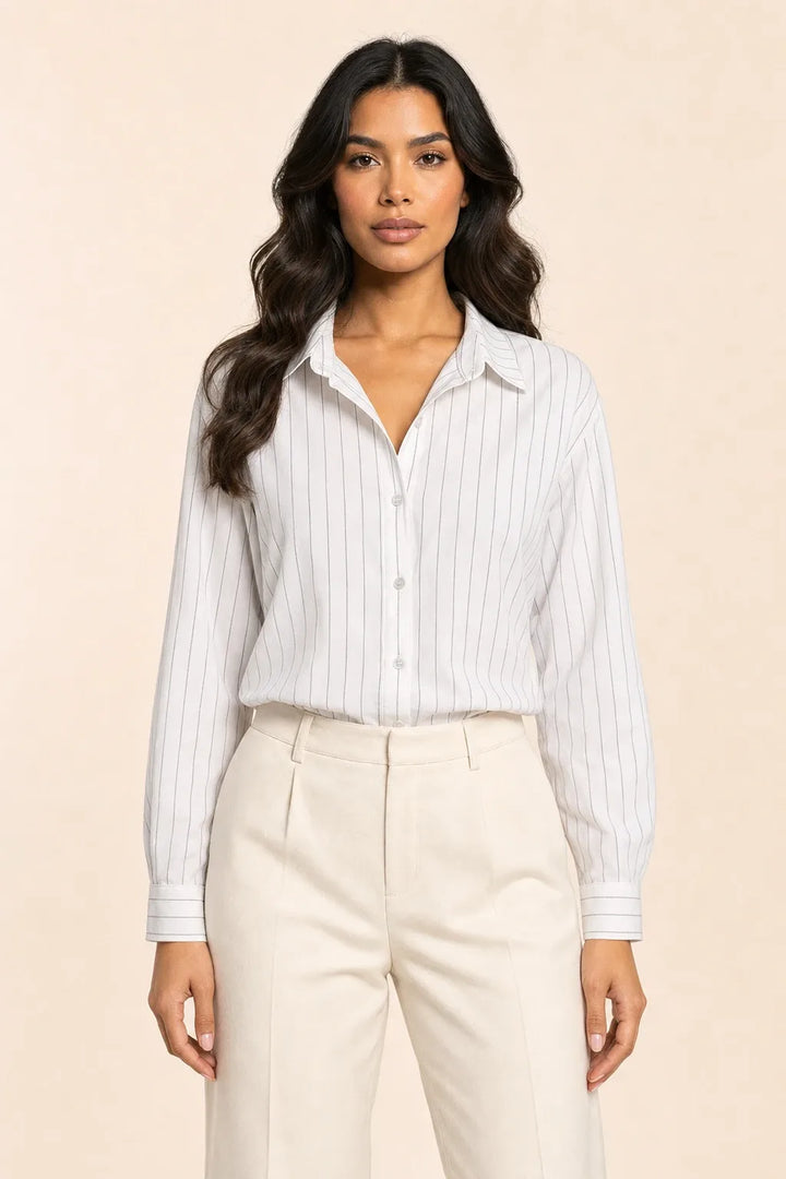 White pinstripe button-front blouse on model in contrapposto stance