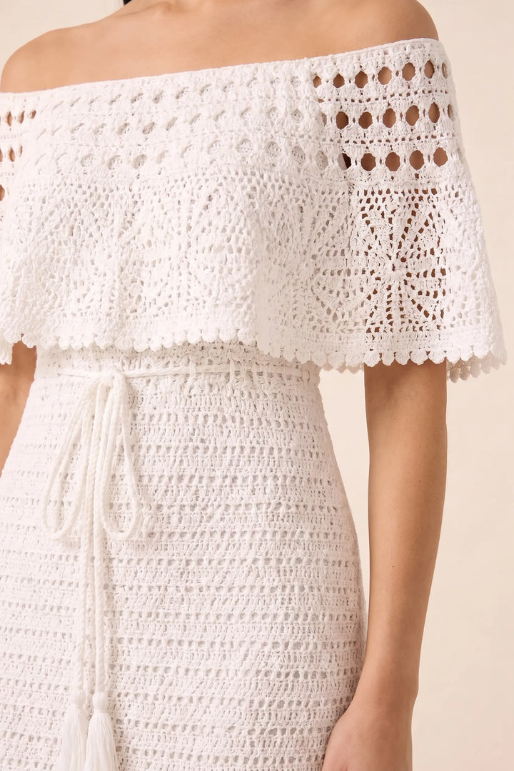 Close-up detail of white crochet ruffle maxi dress fabric and trim