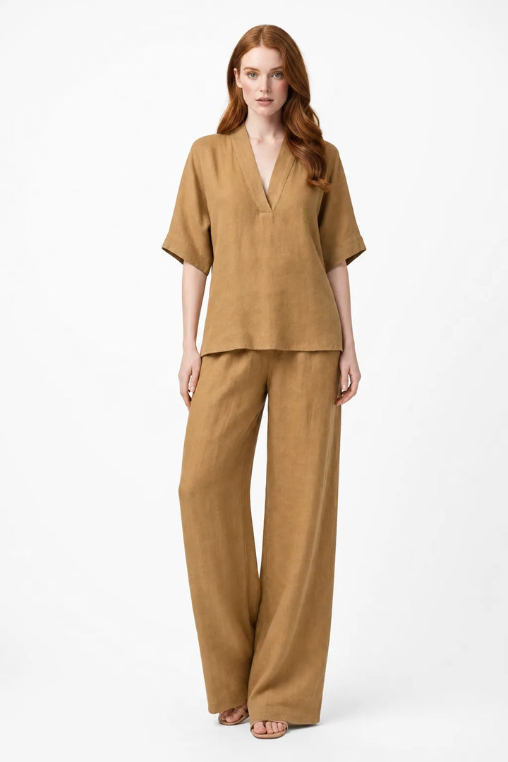 Khaki linen kimono jacket and wide-leg trousers on a model in a contrapposto stance