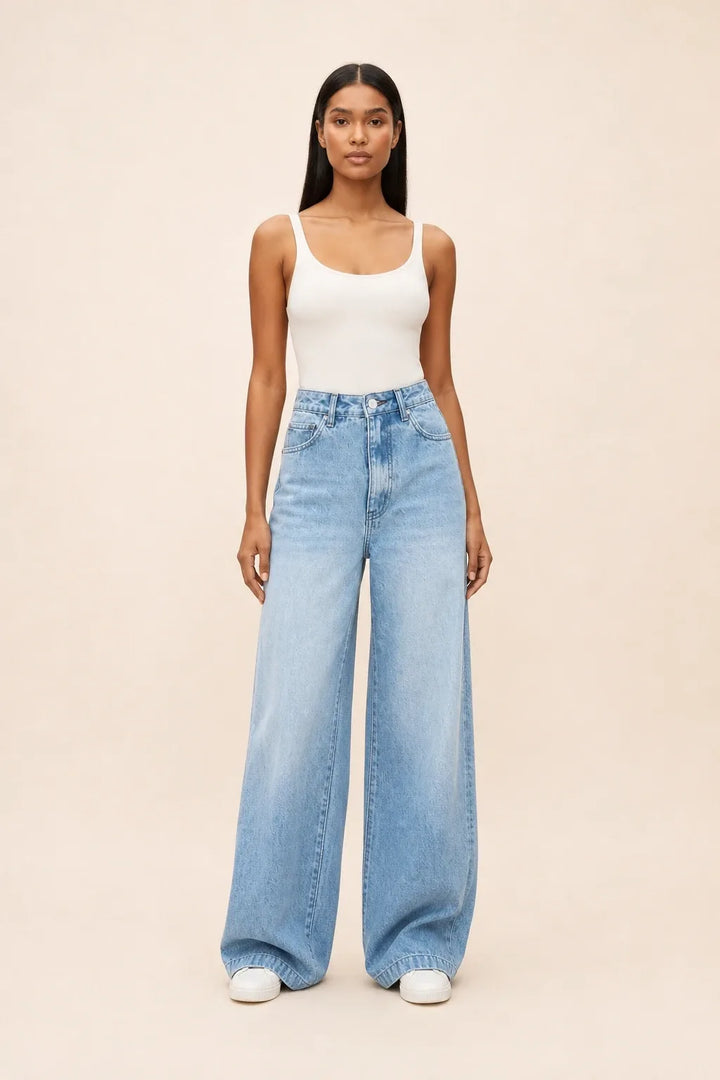 Woman wearing wide-leg blue jeans in a contrapposto stance