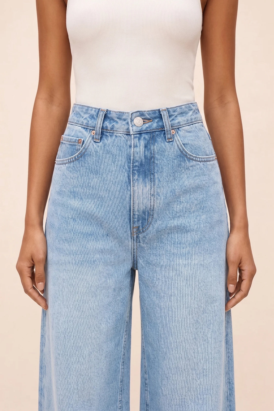 Close-up detail of wide-leg blue denim fabric and stitching
