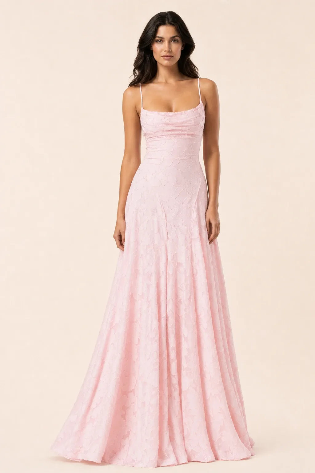 Rose pink lace open-back gown on a model in a contrapposto stance
