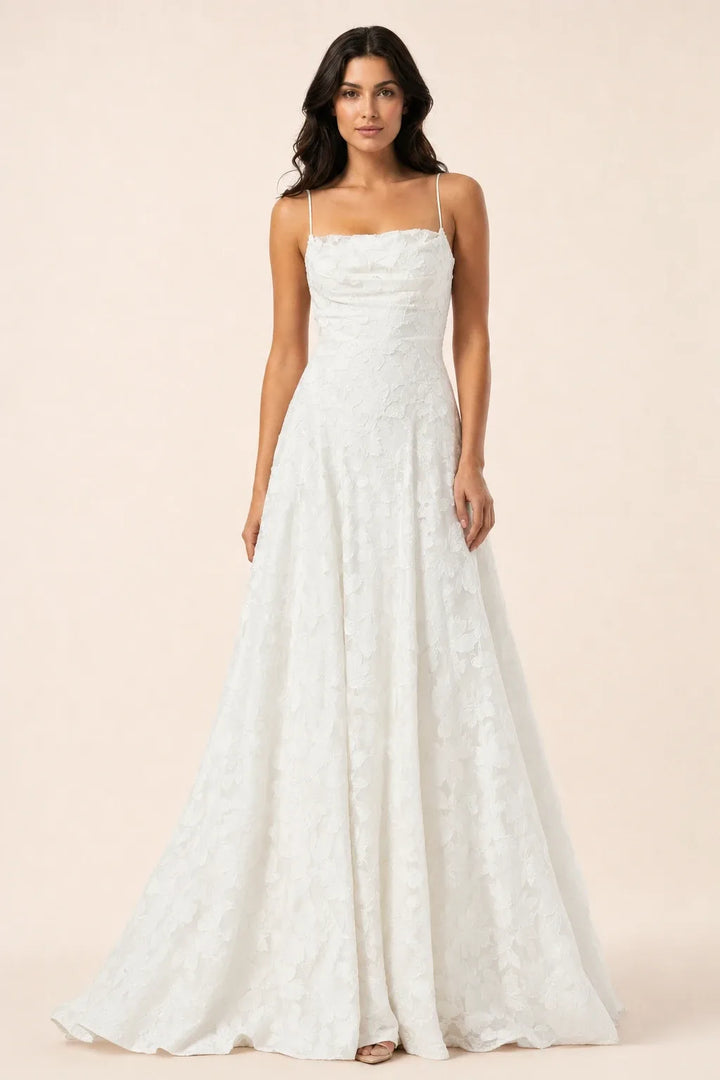 White lace open-back gown on a model in a contrapposto stance