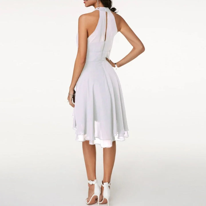 White tiered ruffle halter top on model, three-quarter turn
