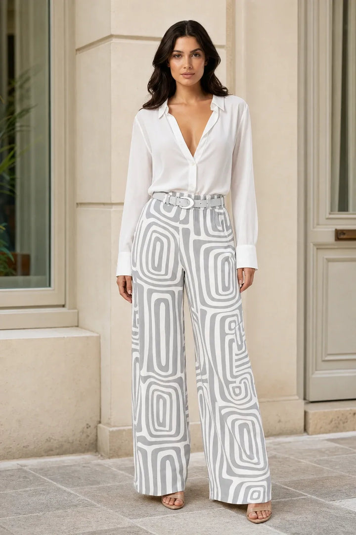 Woman in gray geo print matching trouser set standing in a contrapposto pose