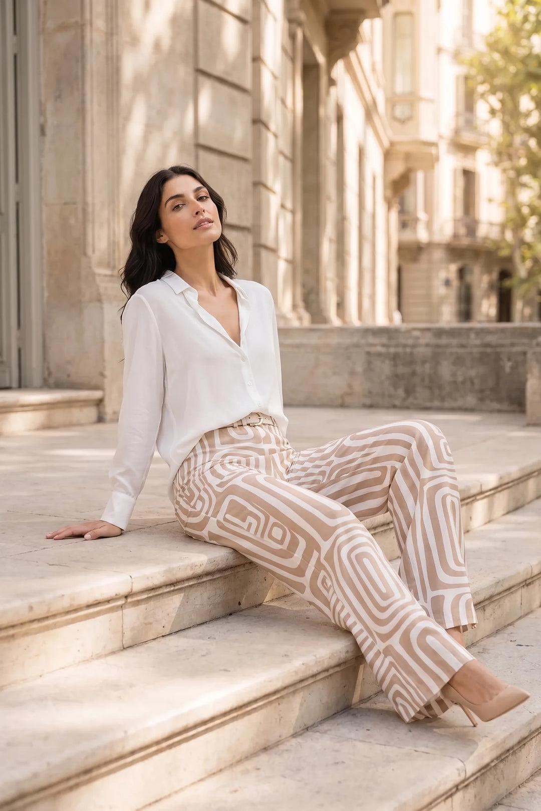 Woman in khaki geo print matching trouser set in an outdoor lifestyle setting
