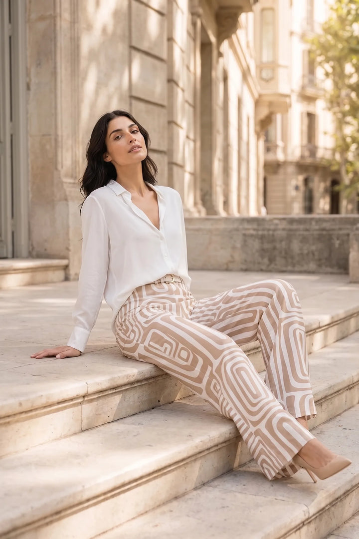 Woman in khaki geo print matching trouser set in an outdoor lifestyle setting