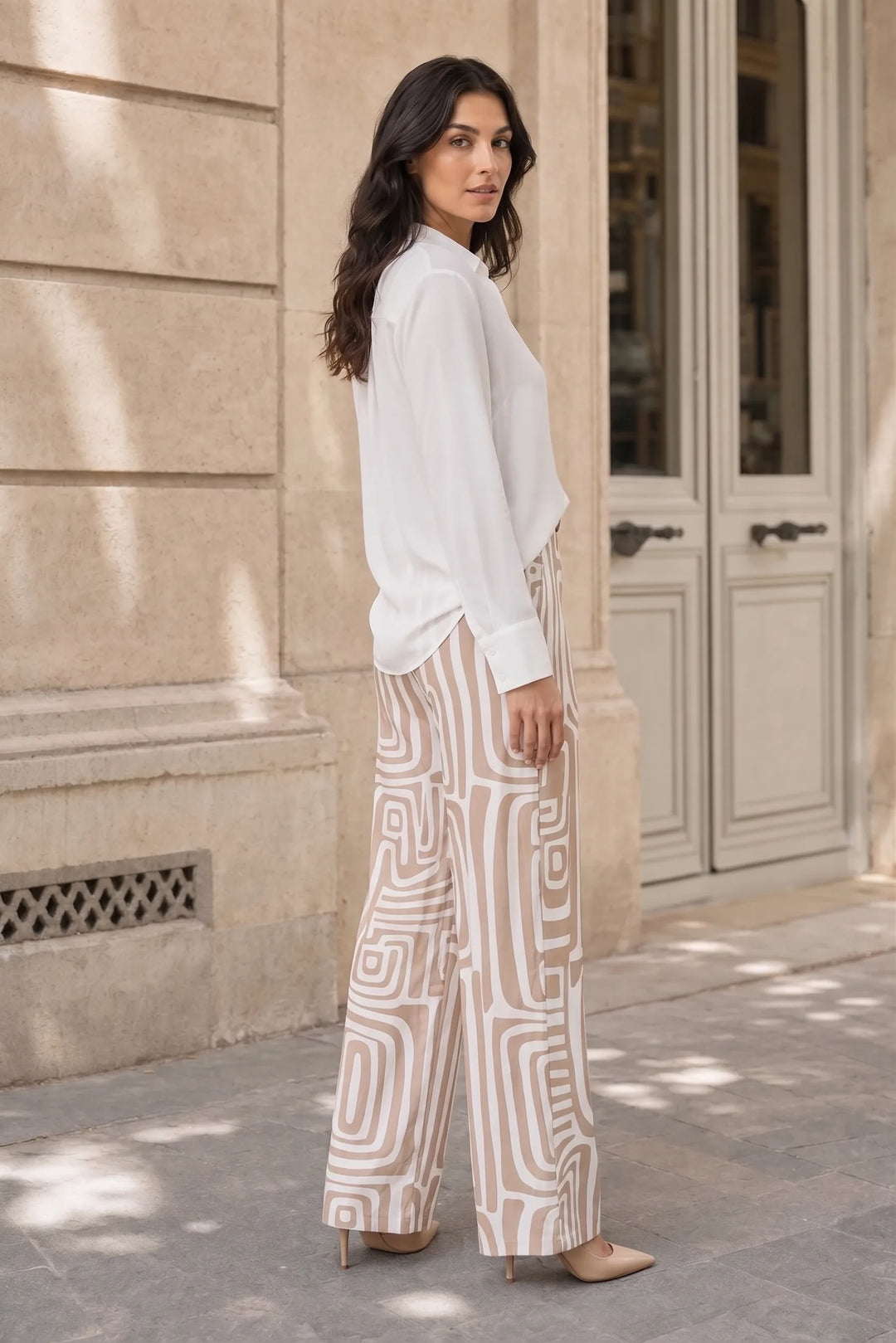 Woman in khaki geo print matching trouser set in a three-quarter turn pose