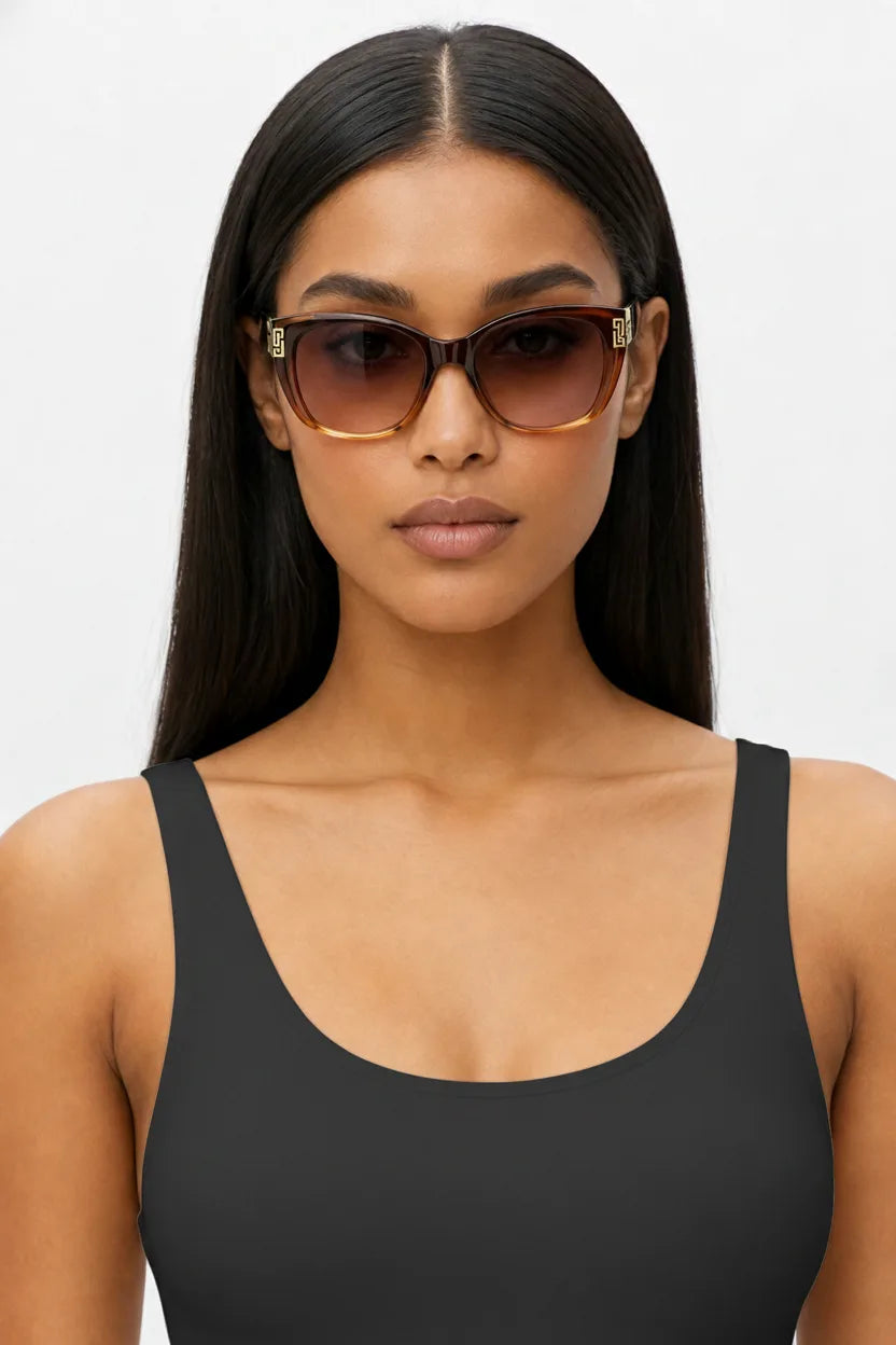 Woman wearing oversized square cat-eye sunglasses in black grey, front-facing close-up