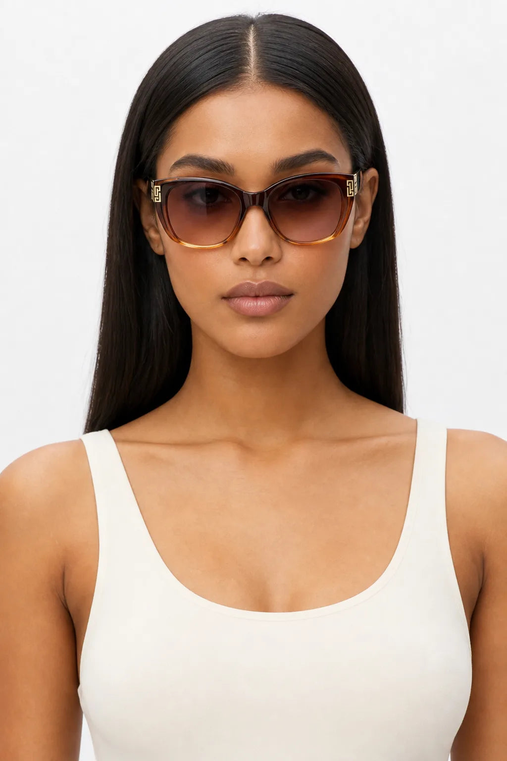 Woman wearing oversized square cat-eye sunglasses in brown gradient, front-facing close-up