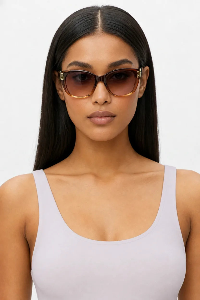 Woman wearing oversized square cat-eye sunglasses in light purple, front-facing close-up