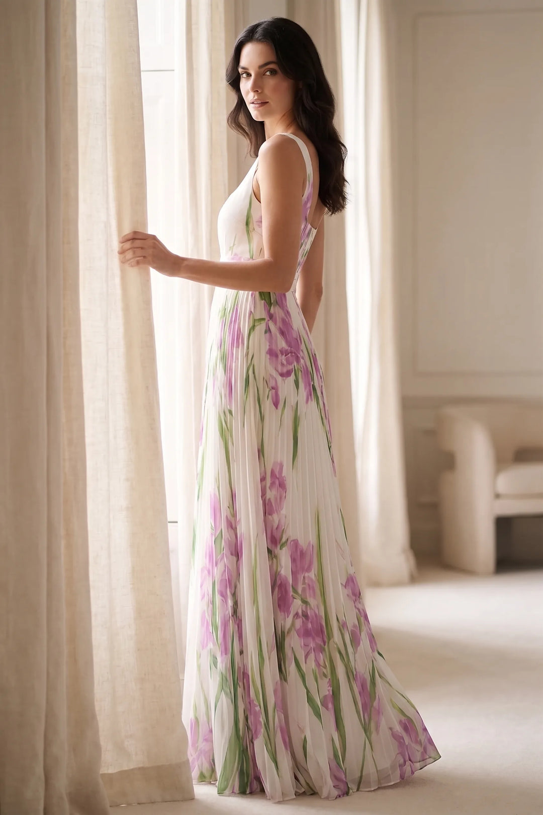 Model wearing white pleated floral gown in lifestyle setting