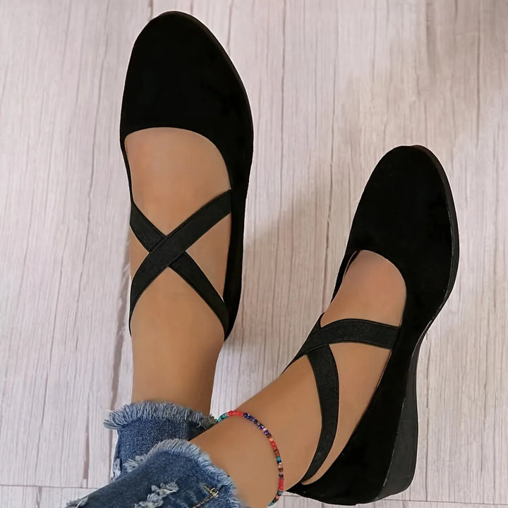 Black cross strap low wedge flat, heel view
