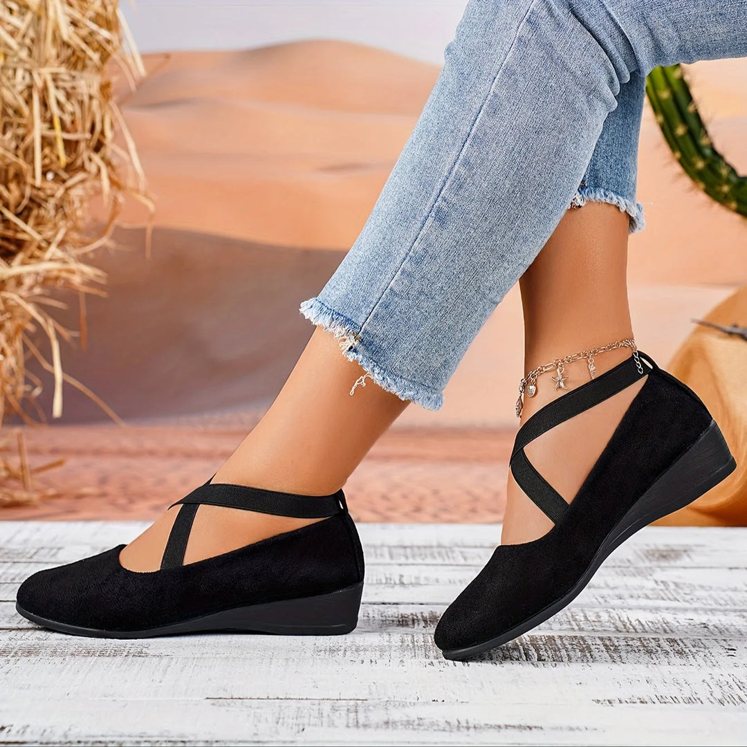 Black cross strap low wedge flat, side profile view